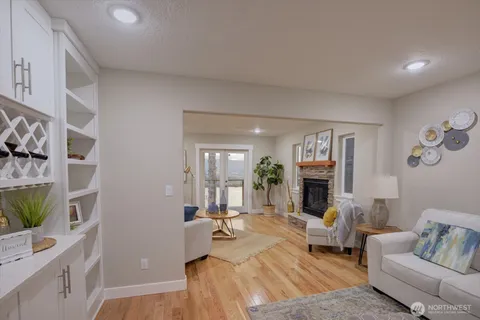 a living room with furniture a fireplace and a flat screen tv