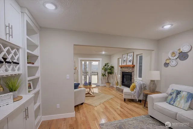 a living room with furniture a fireplace and a flat screen tv