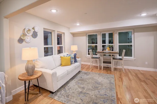 a living room with furniture wooden floor and a table