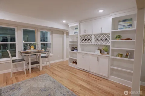 a kitchen with a refrigerator and table chairs