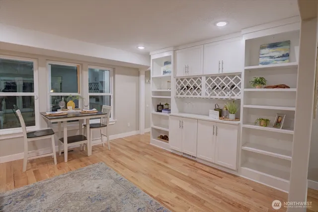 a kitchen with a refrigerator and table chairs