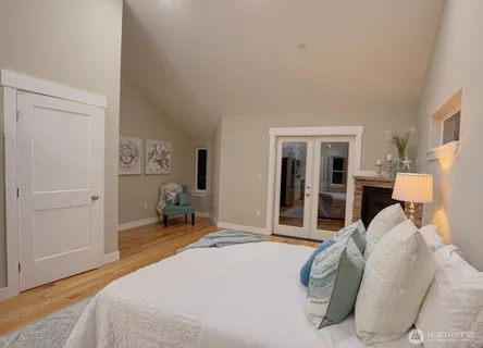 a bedroom with a bed and chair