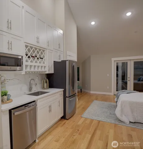 a kitchen with a sink appliances and cabinets