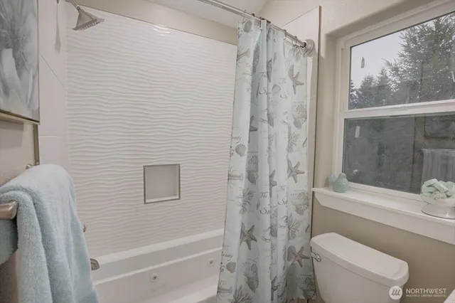 a bathroom with a shower a toilet and a shower