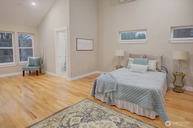 a bedroom with a bed and a large window