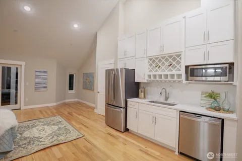 a kitchen with stainless steel appliances a refrigerator sink and microwave