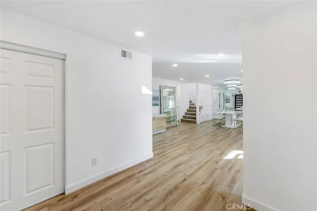 a bathroom with a toilet sink vanity and mirror