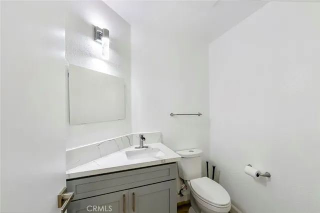 a view of a kitchen with furniture and wooden floor