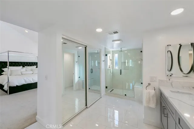 a bathroom with a shower and a glass door