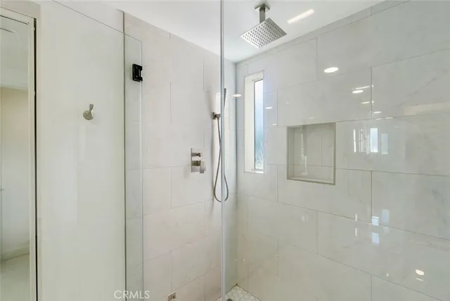 a bathroom with a granite countertop sink a mirror and a shower