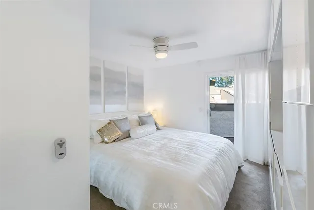 a bedroom with a bed and a painting on the wall