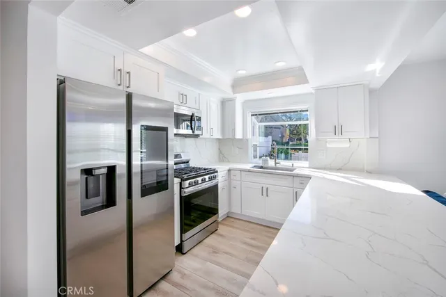 a kitchen with a refrigerator sink and oven
