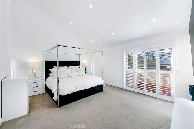 a spacious bedroom with a bed and a window