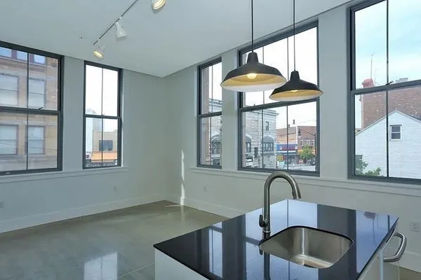 a kitchen with a sink a counter top space and dining table