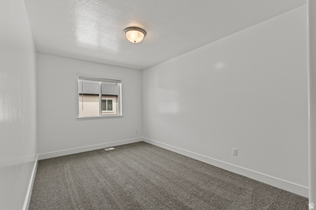 3410 South 1010th Street West Logan, UT 84321 - Photo 13 of 15 Spare room with a textured ceiling and carpet floors
