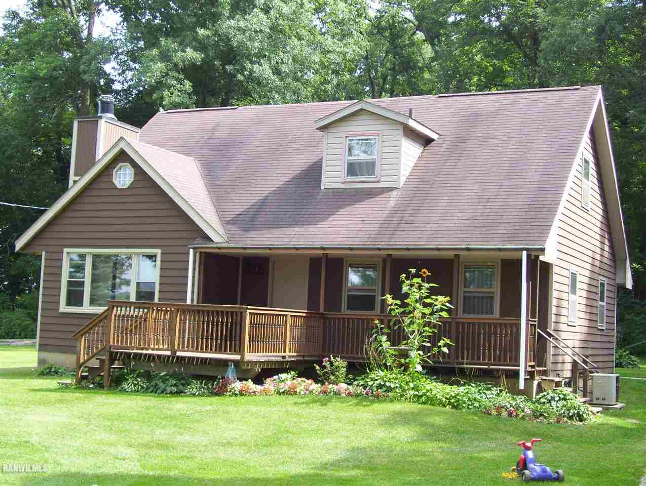 a aerial view of a house with a yard and potted plants