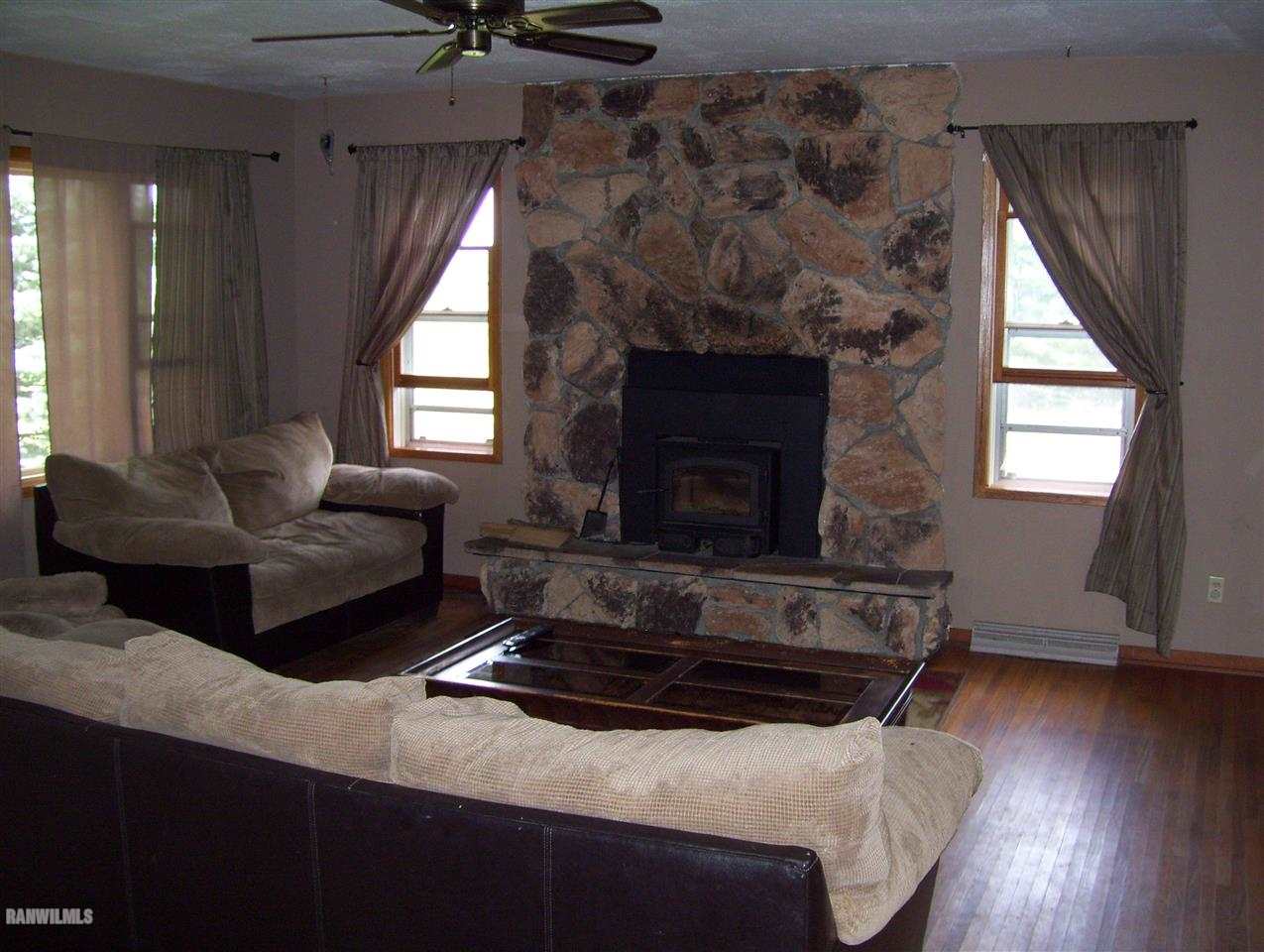17910 Yale Bridge Road Davis, IL 61019 - Photo 3 of 11 a living room with furniture and a fireplace