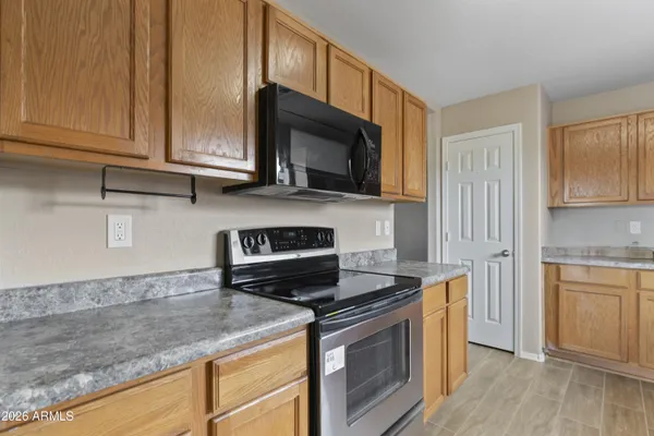a kitchen with stainless steel appliances granite countertop a sink stove and microwave