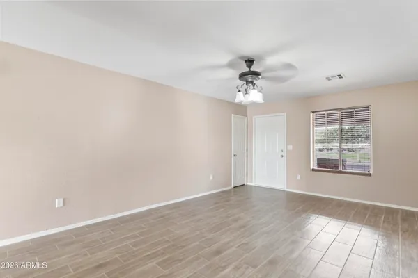 wooden floor in an empty room with a window