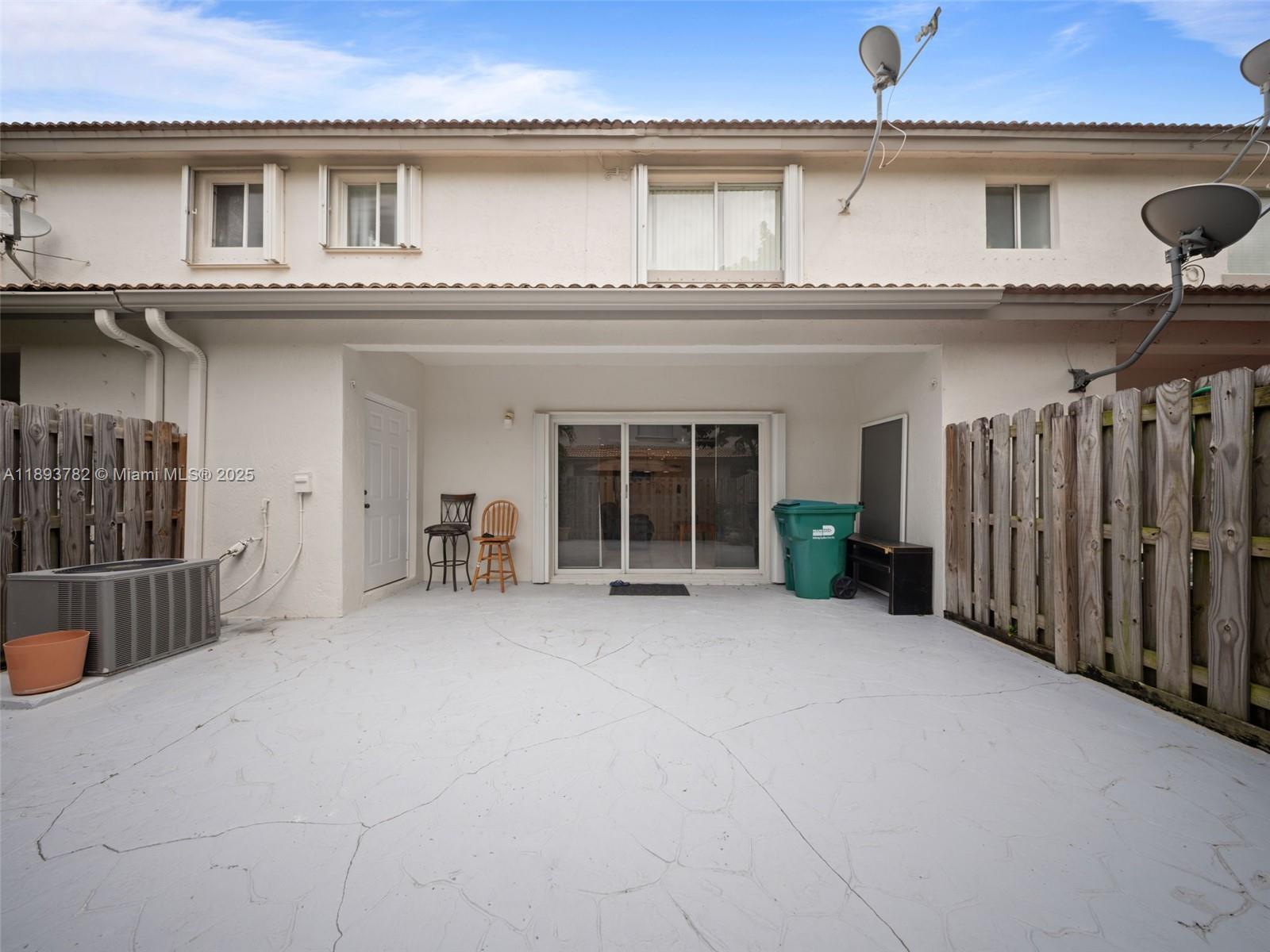 7486 Southwest 162nd Court Miami, FL 33193 - Photo 12 of 47 a view of a house with a wooden fence