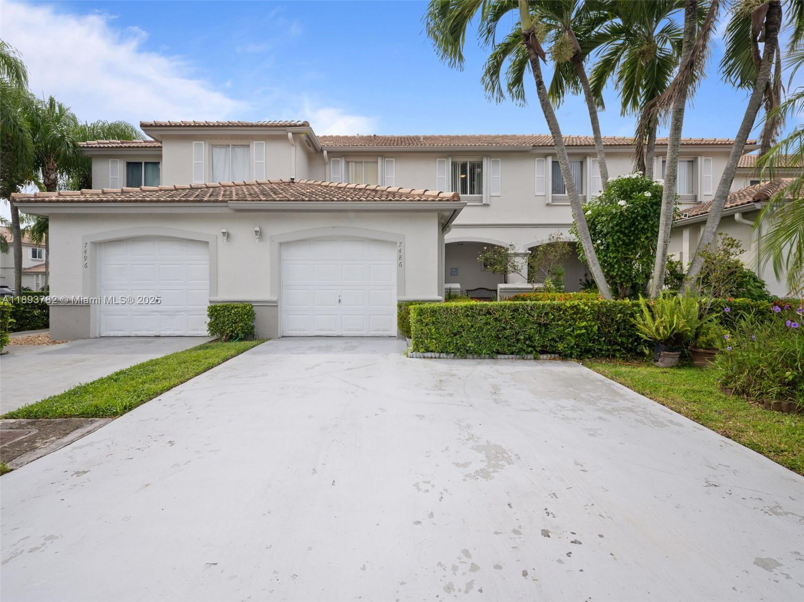 7486 Southwest 162nd Court Miami, FL 33193 - Photo 13 of 47 a front view of a house with a yard and garage