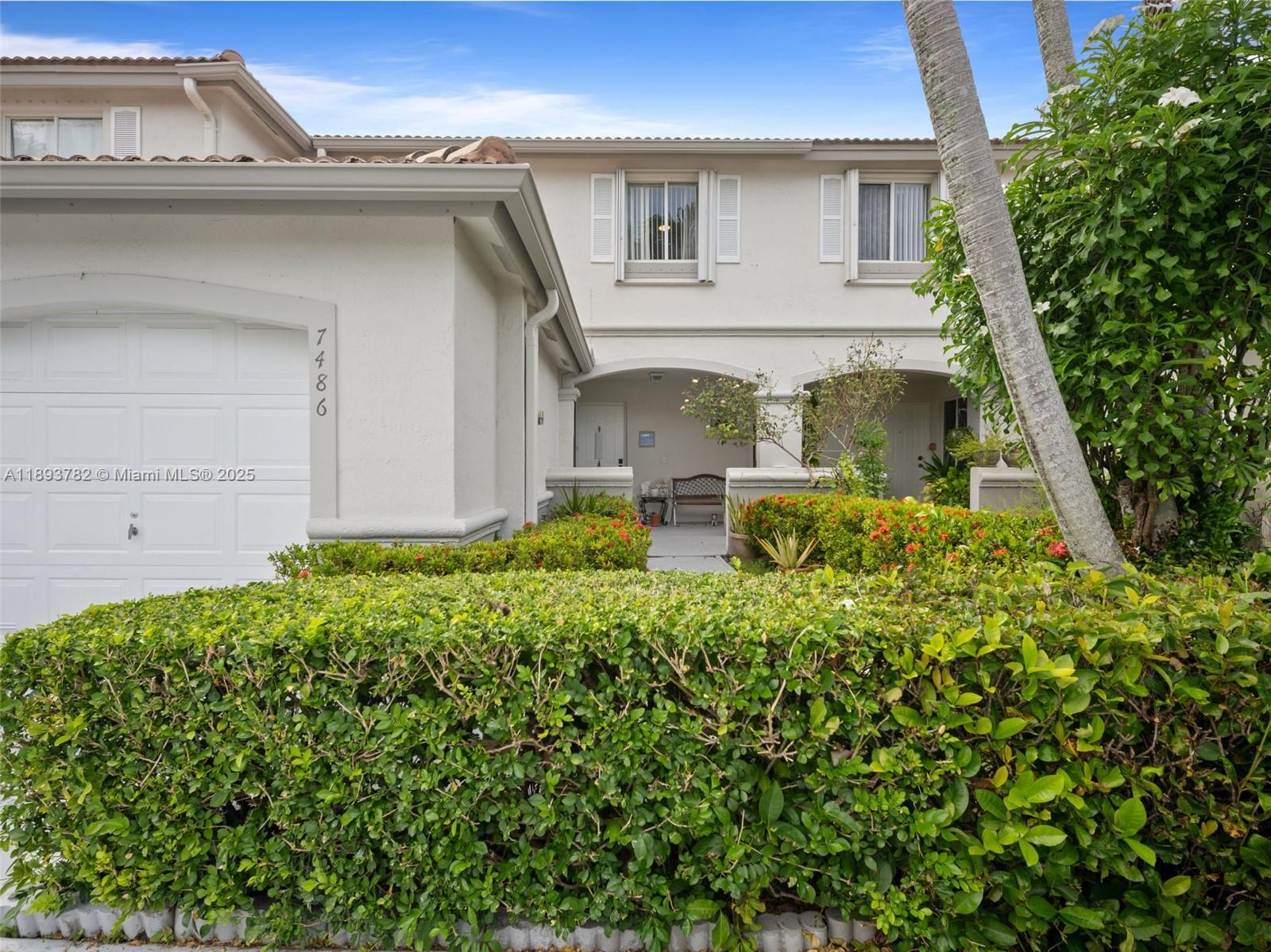 7486 Southwest 162nd Court Miami, FL 33193 - Photo 14 of 47 a front view of a house with garden