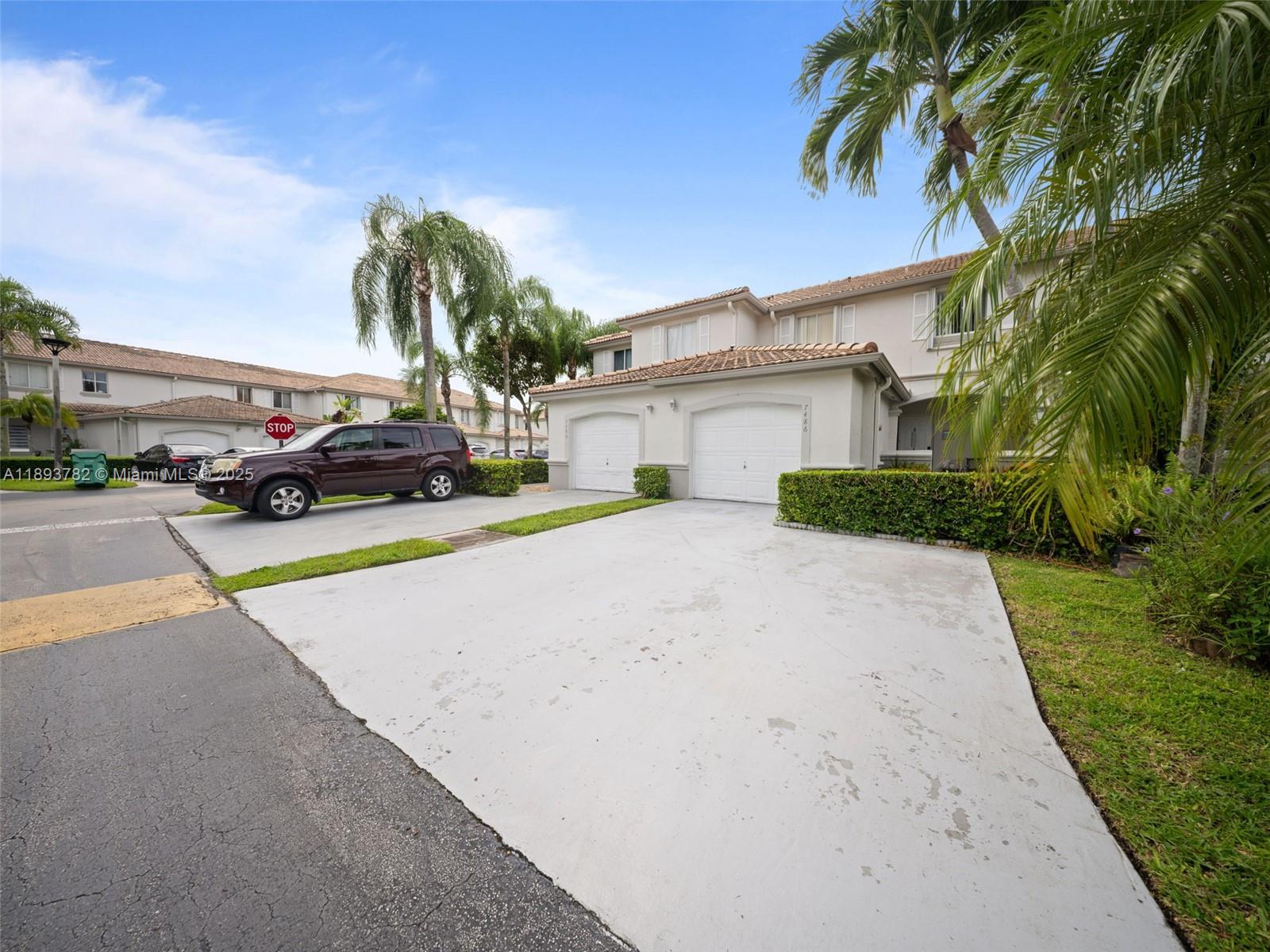 7486 Southwest 162nd Court Miami, FL 33193 - Photo 15 of 47 a view of a house with a yard and palm trees