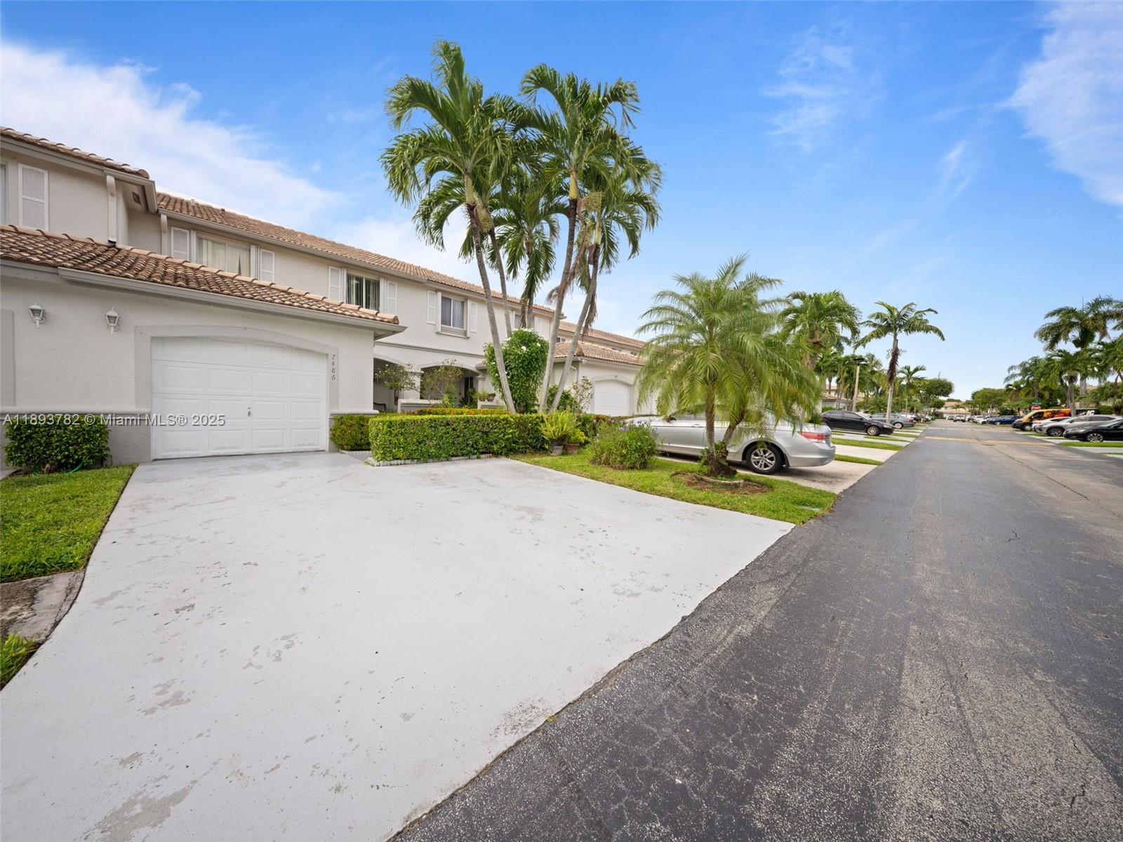 7486 Southwest 162nd Court Miami, FL 33193 - Photo 16 of 47 a front view of a house with a yard and garage