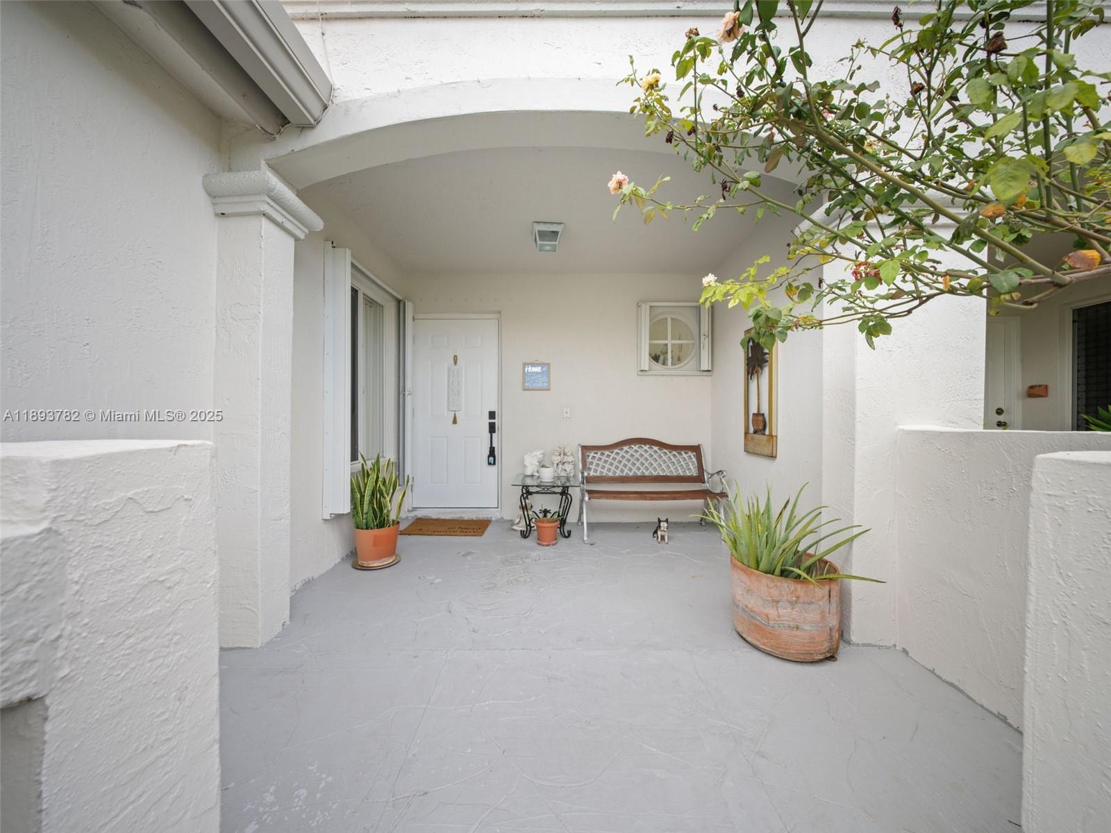 7486 Southwest 162nd Court Miami, FL 33193 - Photo 2 of 47 a lobby with furniture and potted plants