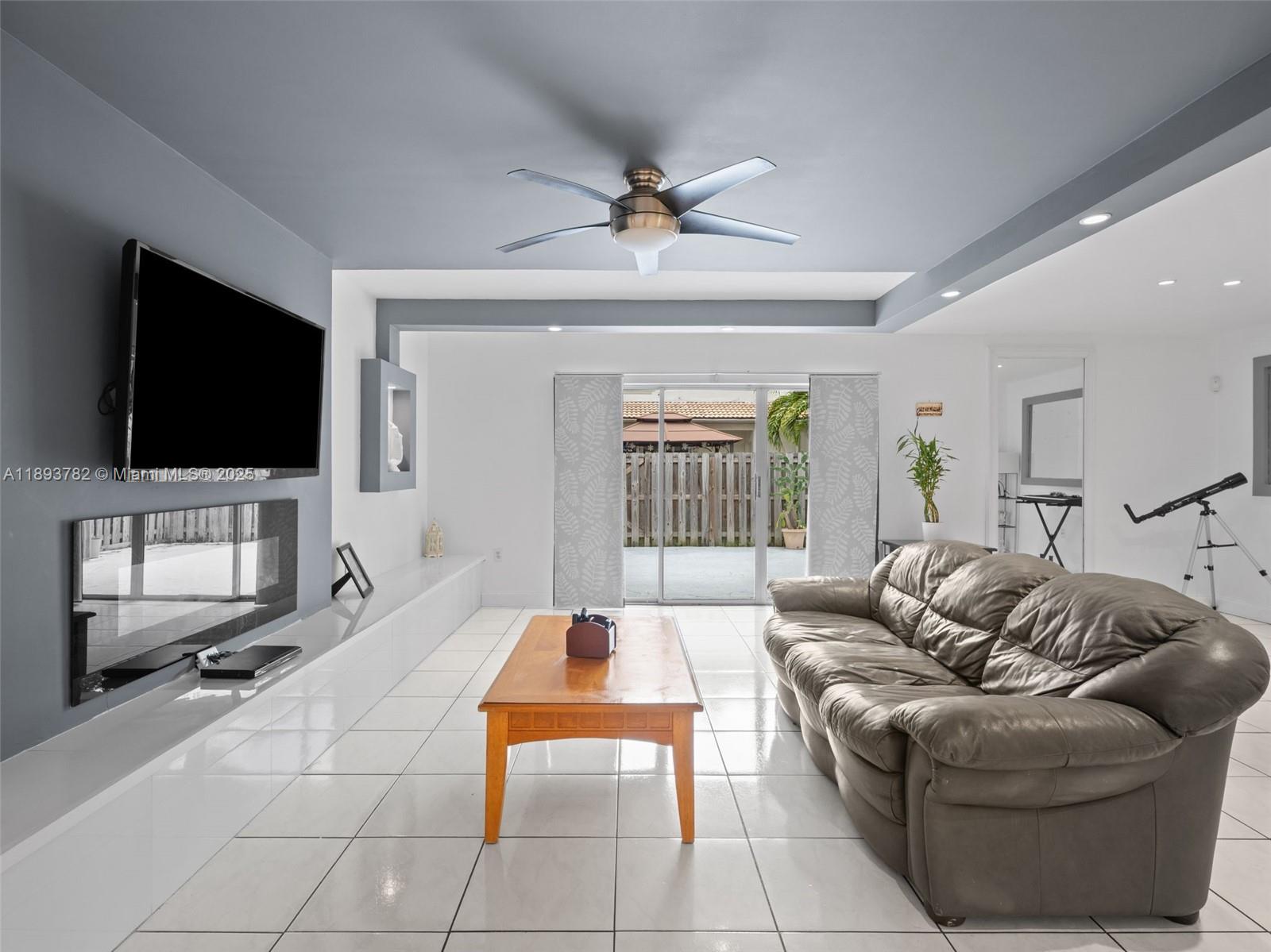 7486 Southwest 162nd Court Miami, FL 33193 - Photo 22 of 47 a living room with furniture and a flat screen tv
