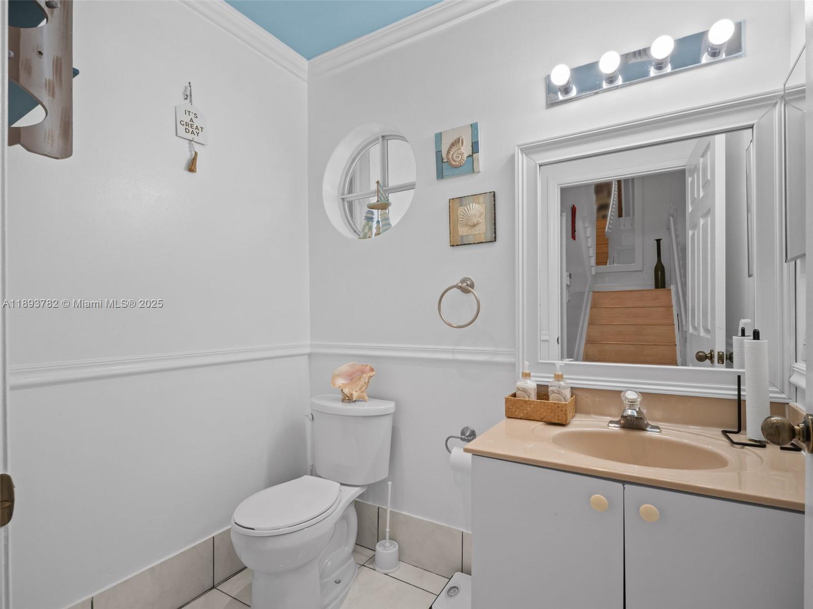 7486 Southwest 162nd Court Miami, FL 33193 - Photo 29 of 47 a bathroom with a toilet sink and mirror