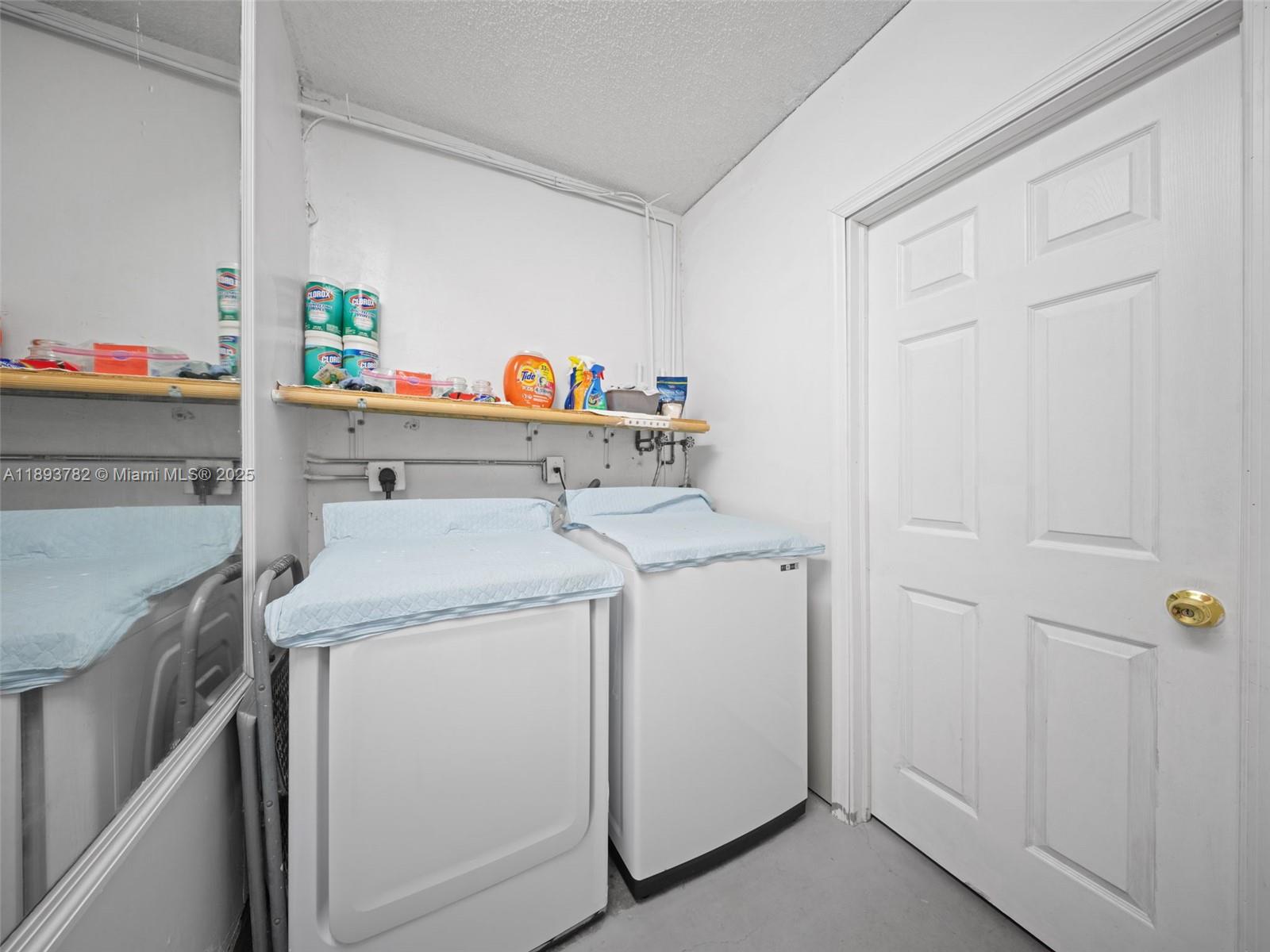 7486 Southwest 162nd Court Miami, FL 33193 - Photo 30 of 47 a utility room with dryer and washer