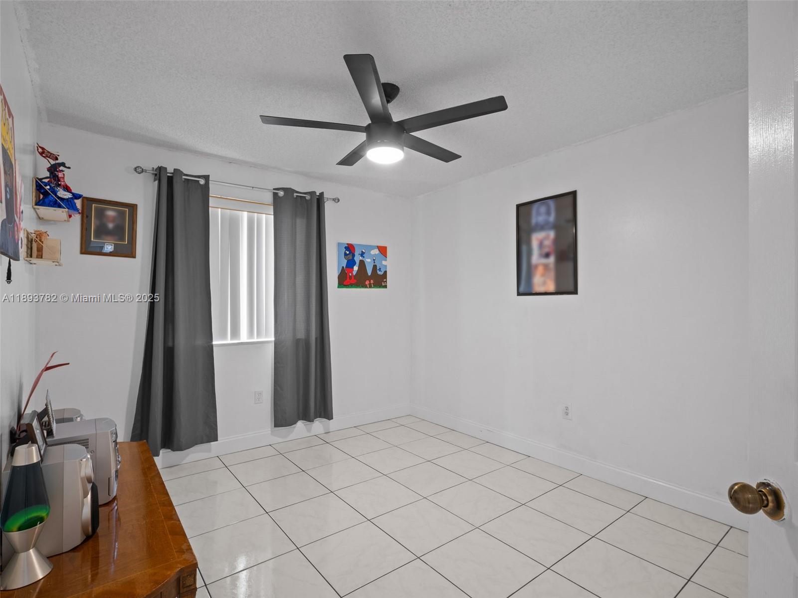 7486 Southwest 162nd Court Miami, FL 33193 - Photo 34 of 47 a very nice looking room with a ceiling fan