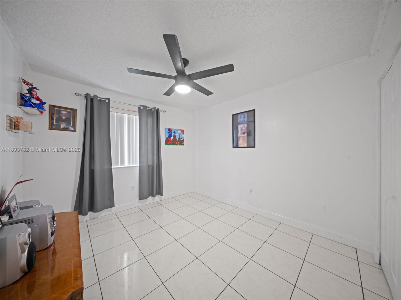 7486 Southwest 162nd Court Miami, FL 33193 - Photo 35 of 47 a view of a livingroom and a chandelier fan