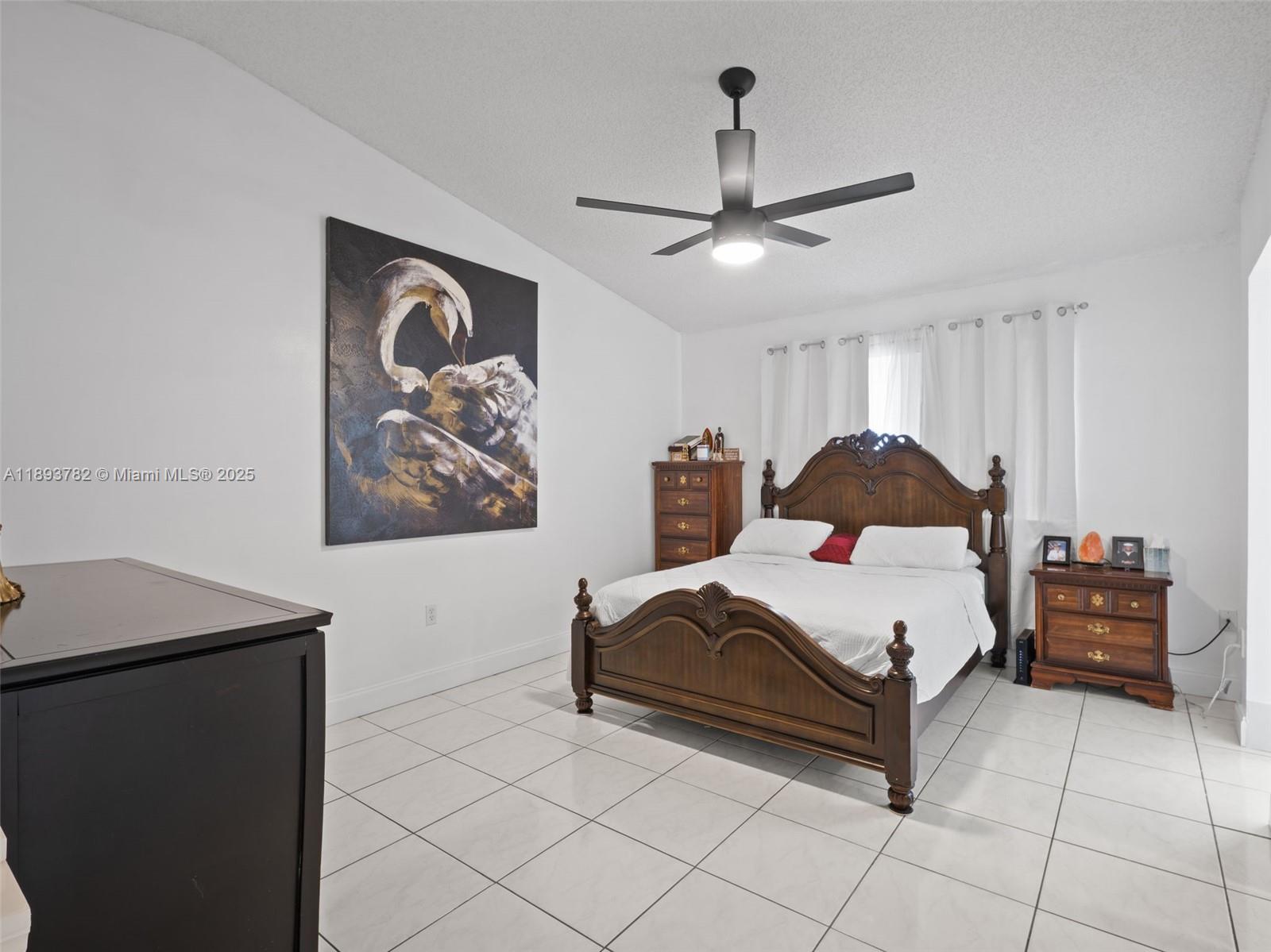 7486 Southwest 162nd Court Miami, FL 33193 - Photo 37 of 47 a bedroom with a bed and a chandelier