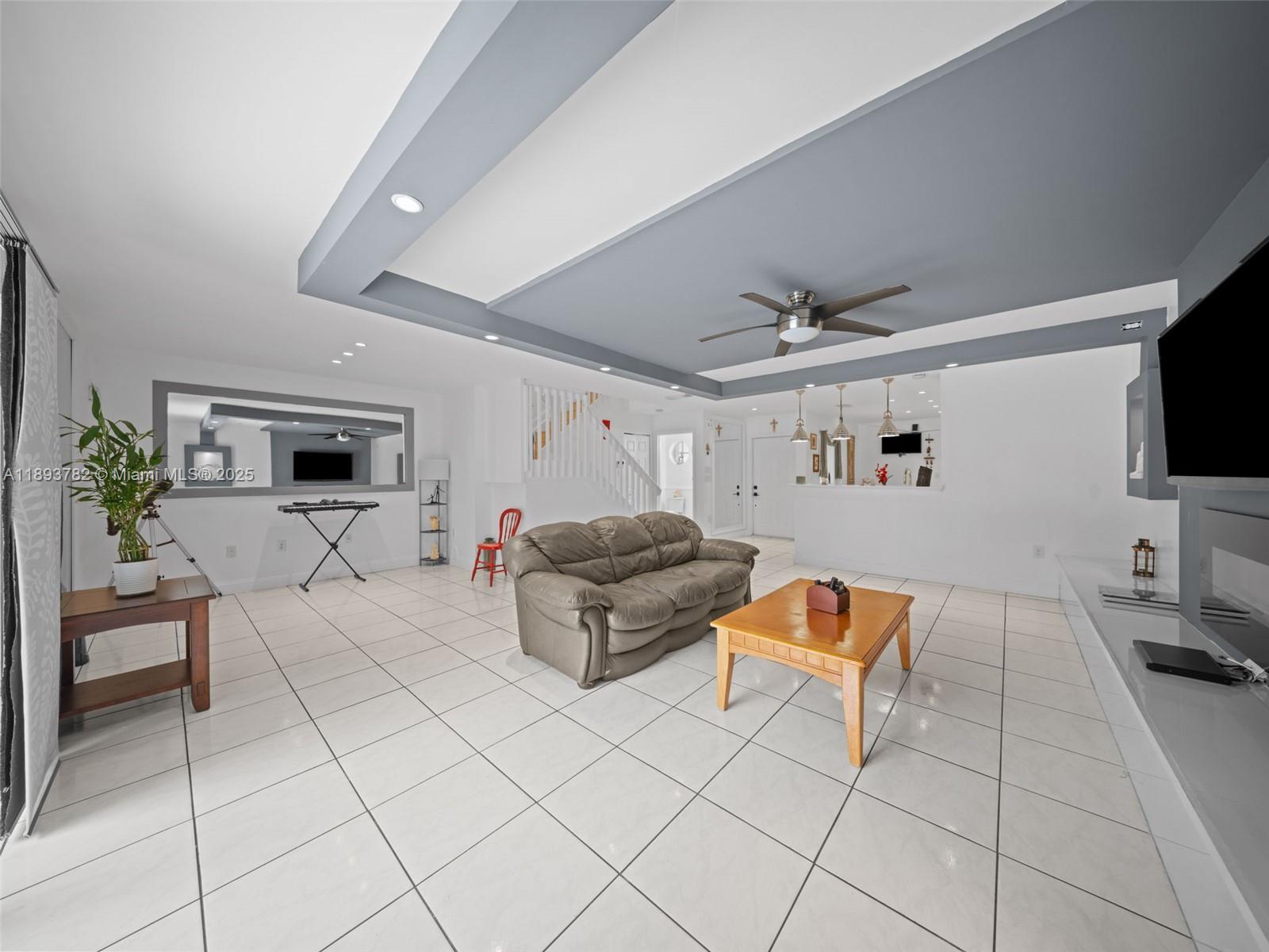 7486 Southwest 162nd Court Miami, FL 33193 - Photo 5 of 47 a living room with furniture and a flat screen tv