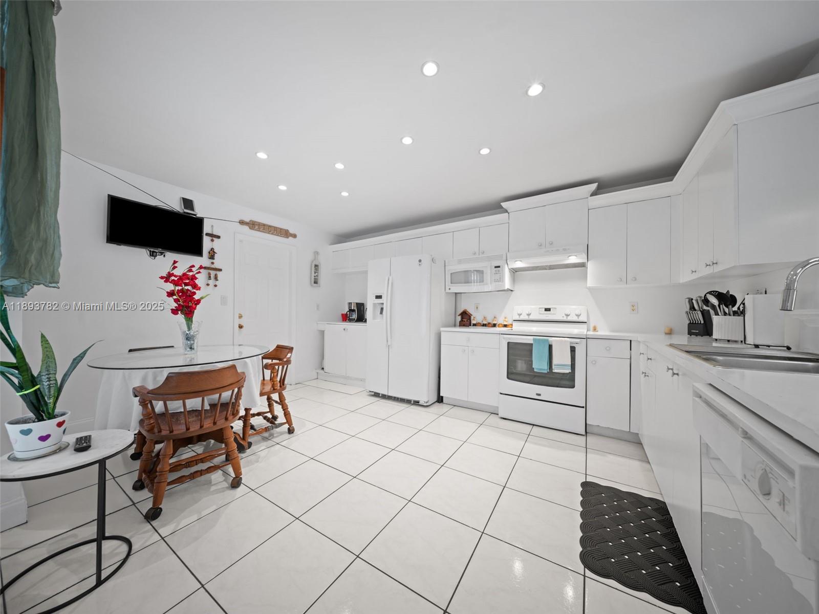 7486 Southwest 162nd Court Miami, FL 33193 - Photo 8 of 47 a living room with furniture and a flat screen tv