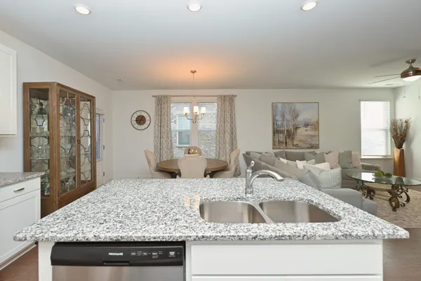 a kitchen with sink and mirror