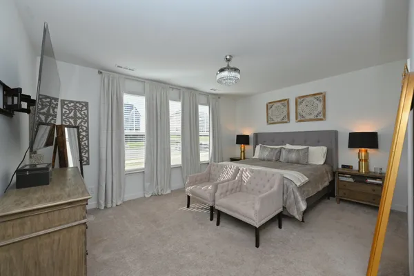 a spacious bedroom with a bed and a walk in closet