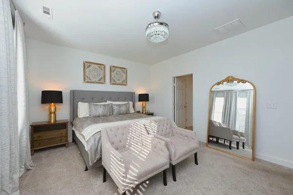 a bedroom with a bed and a lamp on table