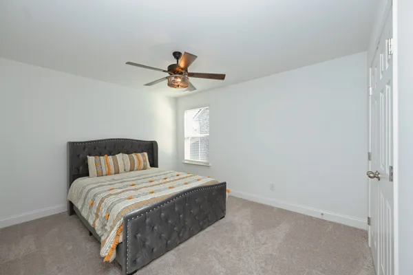 a bedroom with a bed and a chandelier