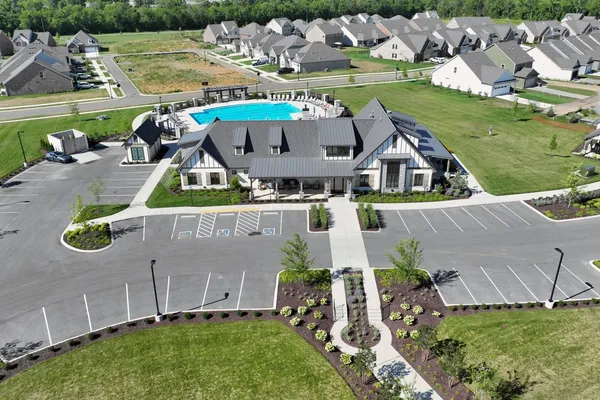 an aerial view of a house with a garden and swimming pool