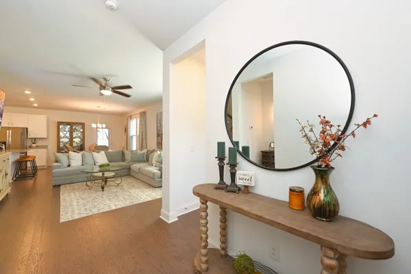 a living room with furniture and a mirror