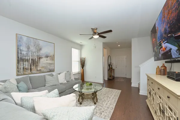 a living room with furniture and a chandelier