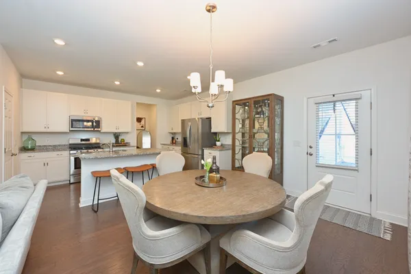 a dining room with furniture a window and kitchen view