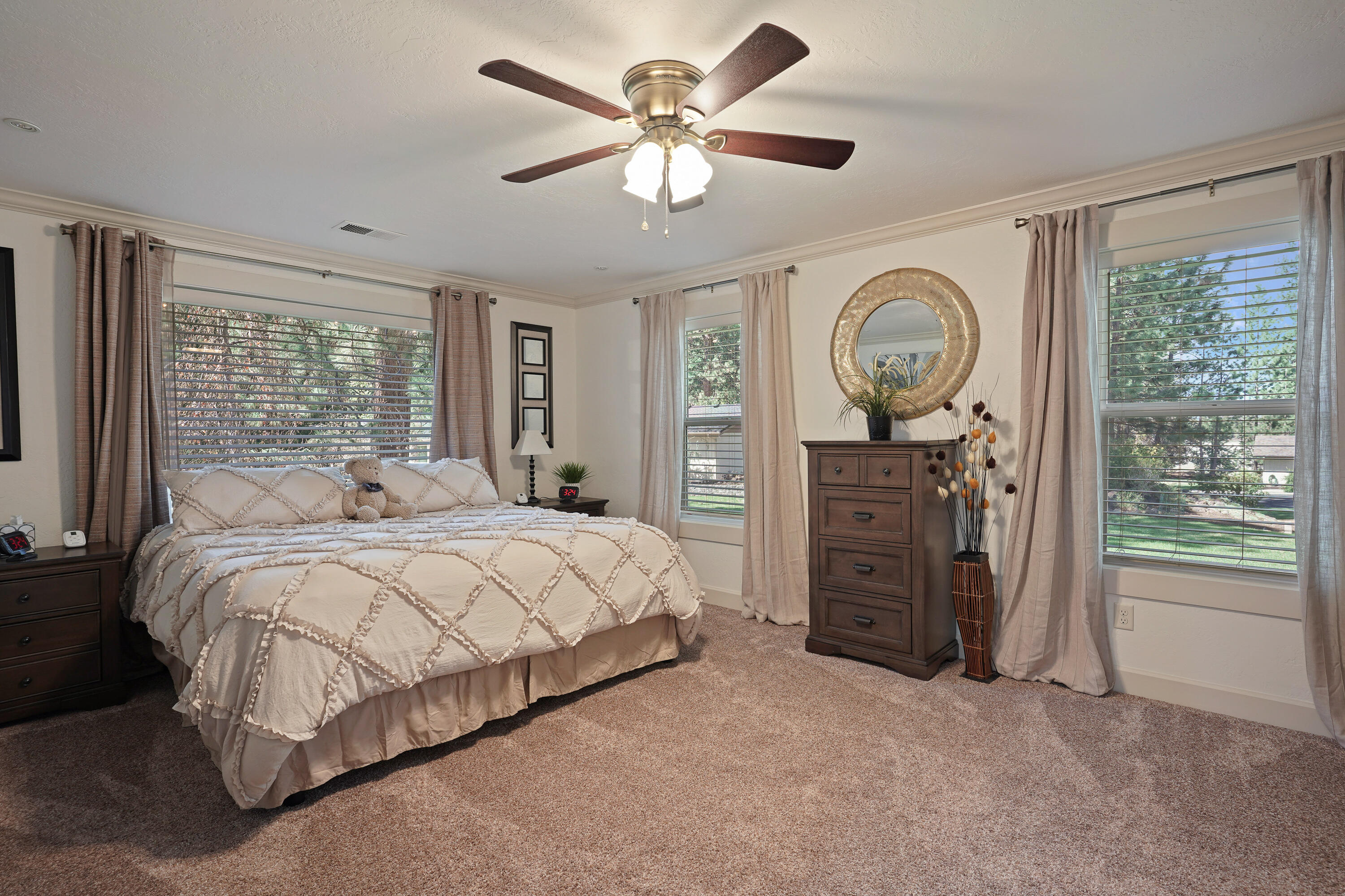 20452 Mainline Road Bend, OR 97702 - Photo 19 of 40 a spacious bedroom with a bed a dresser and a large window