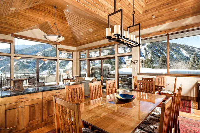 a view of a dining room with furniture large windows and wooden floor