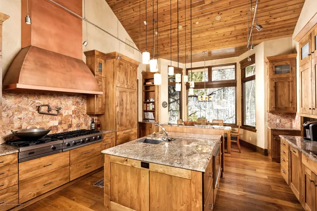 a kitchen with stainless steel appliances granite countertop a stove and cabinets