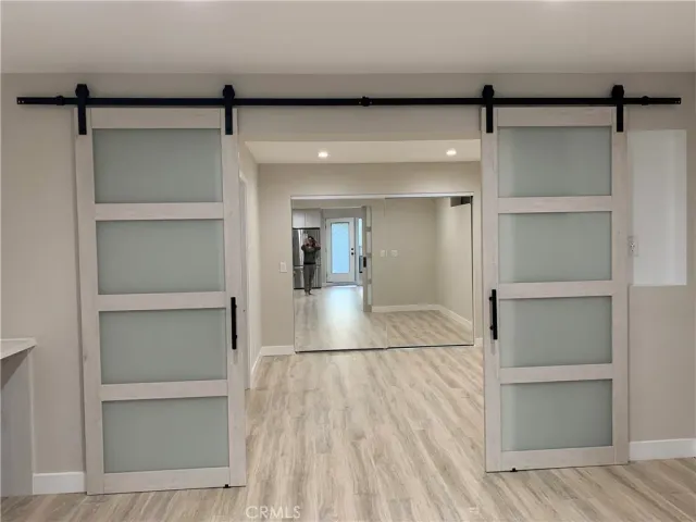 a view of a room with wooden floor