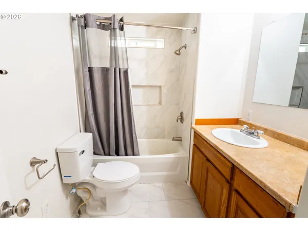 a bathroom with a sink toilet vanity and shower